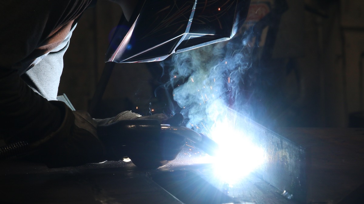 A worker welding metal