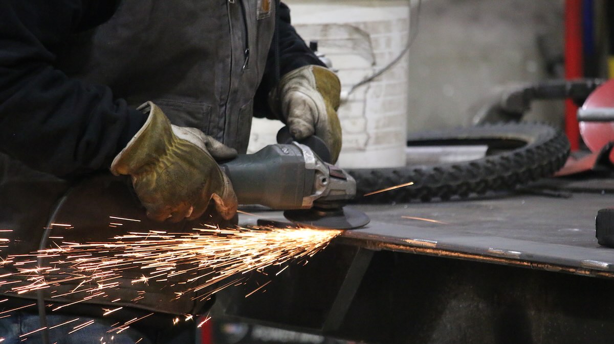 A worker fabricating metal