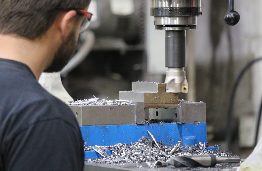A worker operating a metal fabrication machine