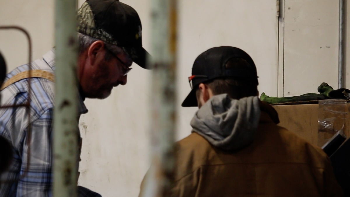 A worker talking with his supervisor in a workshop